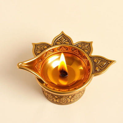 Hand-cast brass diya with intricate engraving